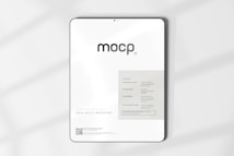 A digital mockup featuring a tablet with a minimalistic design. The screen displays a sleek interface with the word 'mocp' prominently at the top. Below it, there's information about features such as very realistic output and fully editable resolution. The background is clean and white, accented by soft shadows.
