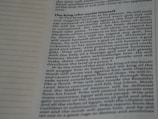A close-up image of a page from a book or document, featuring English text printed in a block format. The text is densely packed with paragraphs and headings in bold, indicating different sections. The paper is light-colored, and the text is black with a readable, standard font. On the left side, there is a margin with evenly spaced dotted lines.