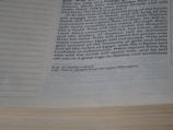 A page of a book with text visible in a column format. The text discusses historical or biblical content regarding kings, battles, and regions such as Egypt and the North, including references and footnotes at the bottom.
