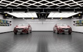 A modern garage space with cars being detailed and prepped for sale.