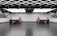A modern garage with two identical red cars parked side by side. The ceiling features geometric, grid-like lighting that is bright and reflective. The walls are decorated with colorful car detailing supplies. The floor has a textured, dark tile surface.