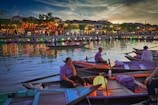 Vibrant lanterns glowing over Fenghuang’s riverside old town at dusk.