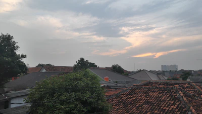 Before and after shots showing a complete roof replacement on a residential property in Manhattan.