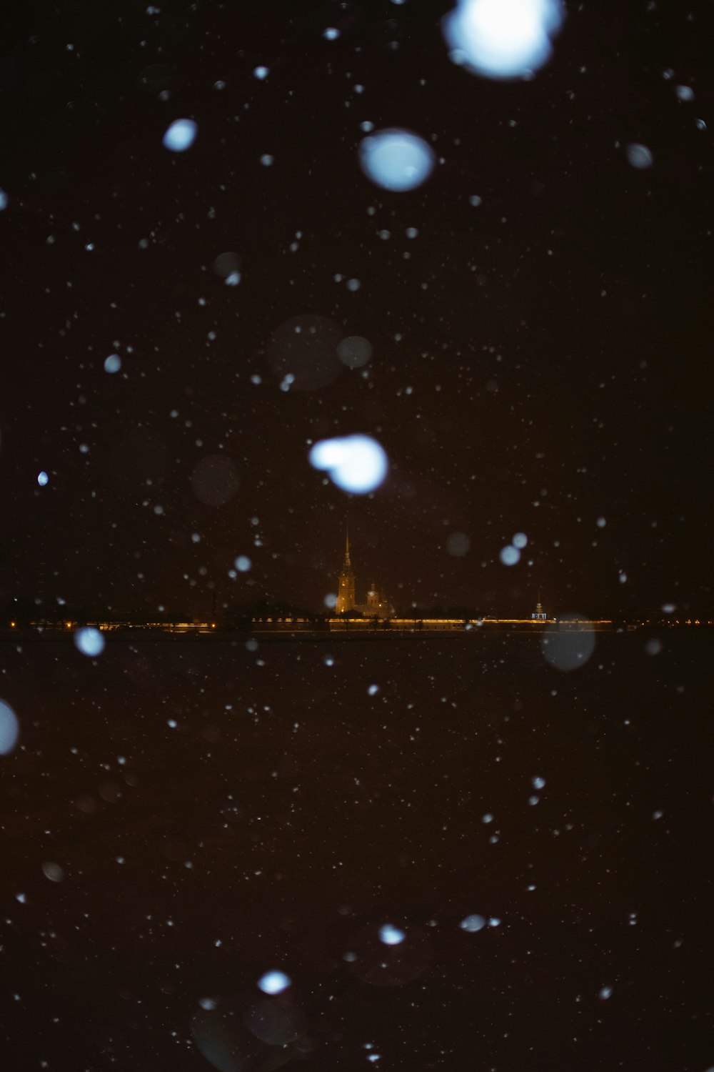 a view of a city at night in the snow