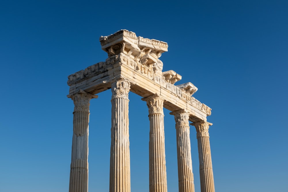 a tall stone structure with four pillars