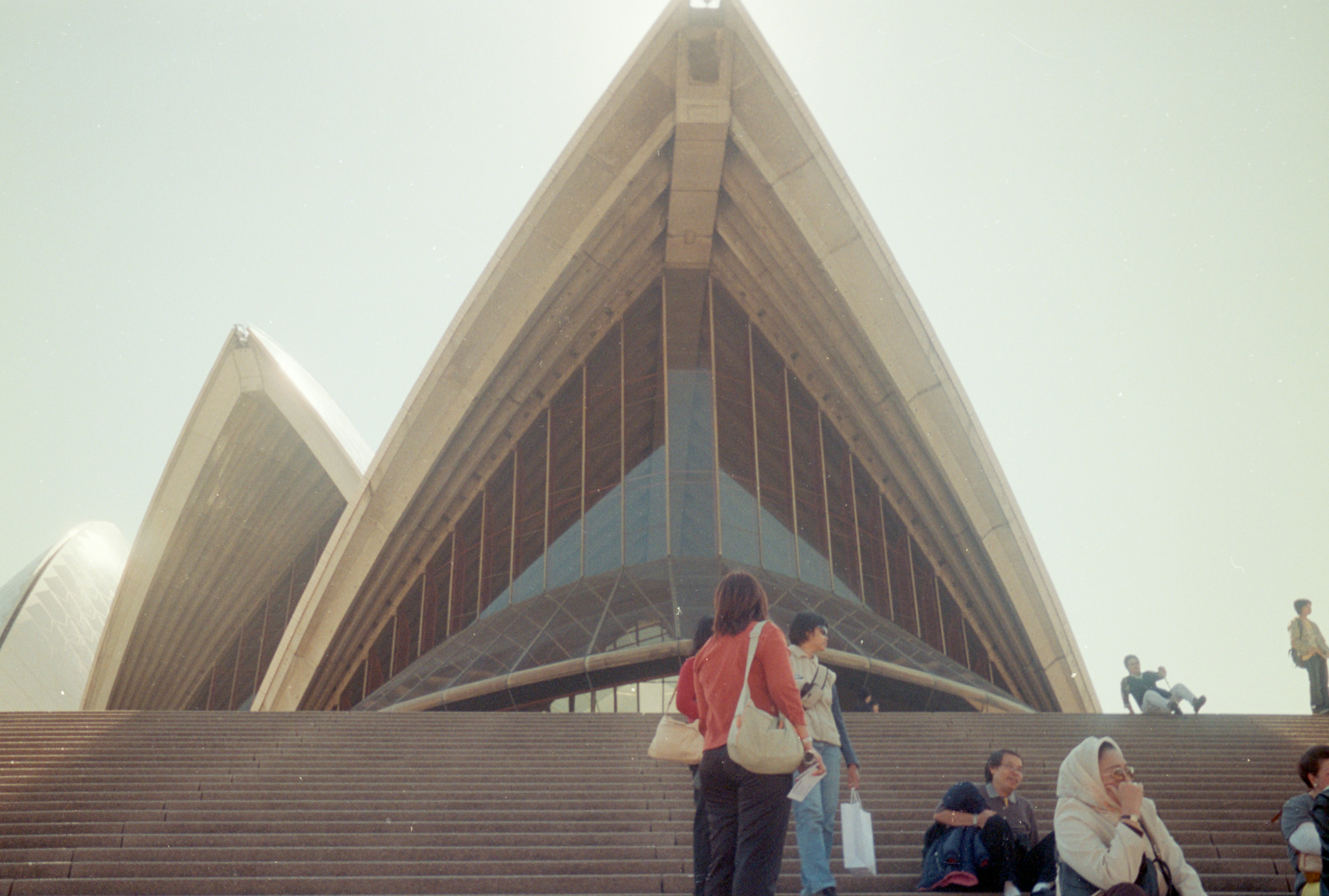 a group of people sitting on the steps of a building