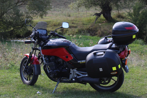 A motorbike equipped with motovanta parts parked against a scenic Malaysian backdrop.