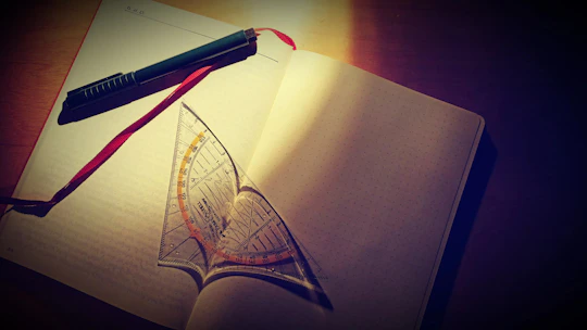 Student smiling while studying with elegant gold-accented stationery nearby.