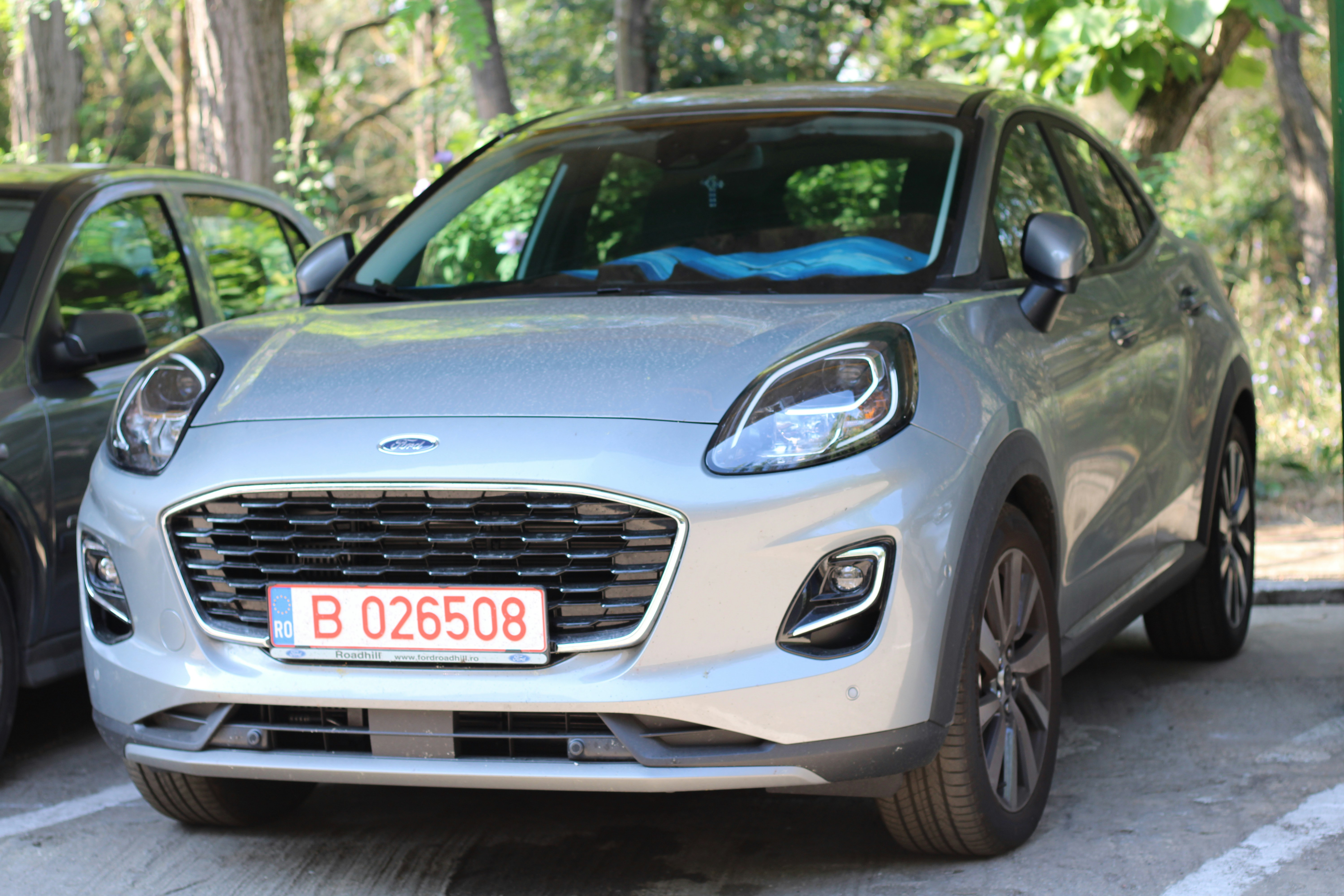 two cars parked next to each other in a parking lot