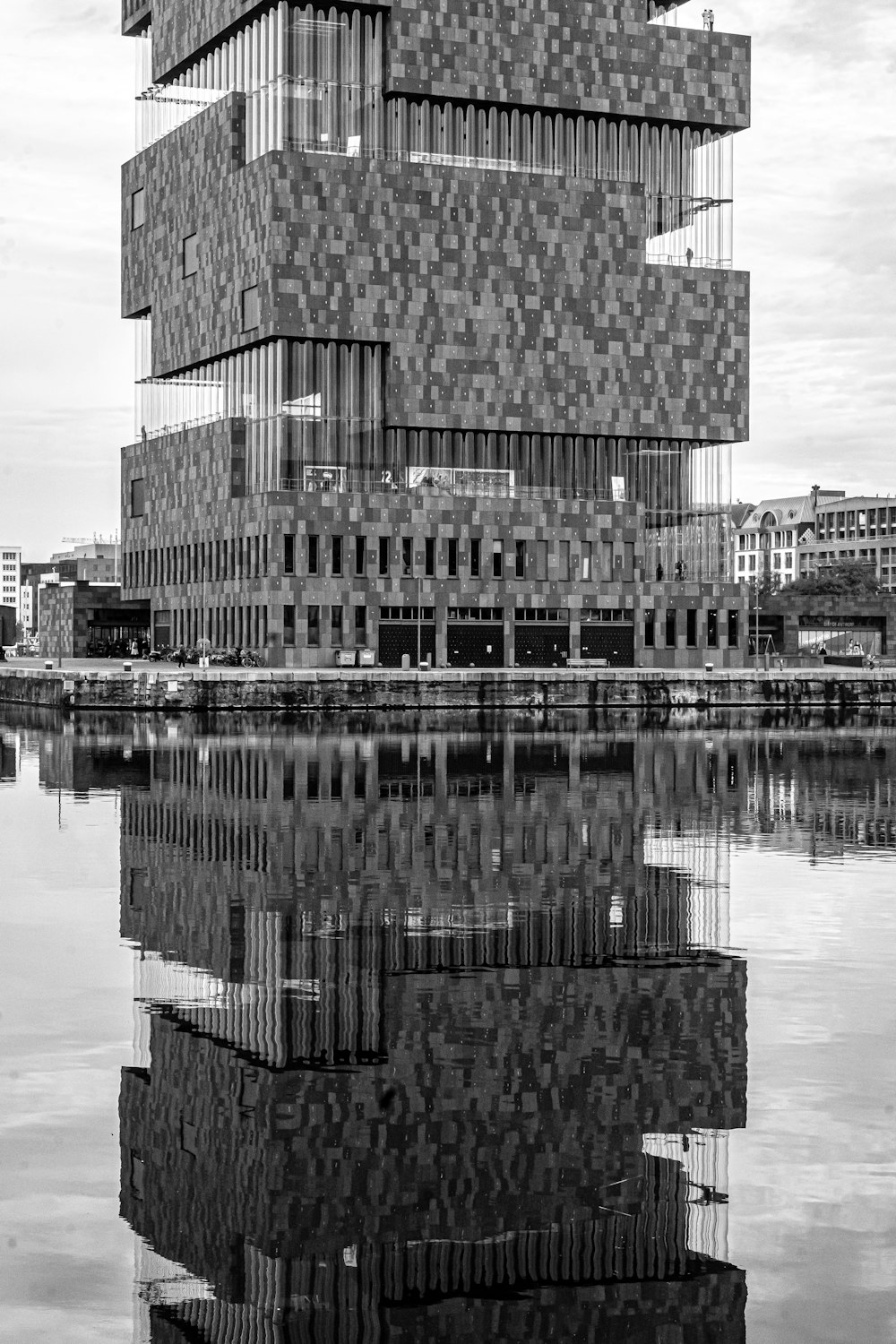 a tall building sitting next to a body of water