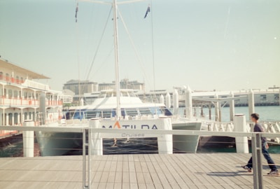 a man riding a skateboard down a wooden pier