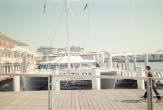 a man riding a skateboard down a wooden pier