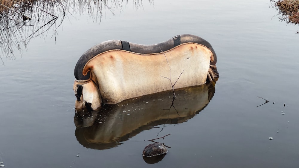 an old boat in the middle of a body of water