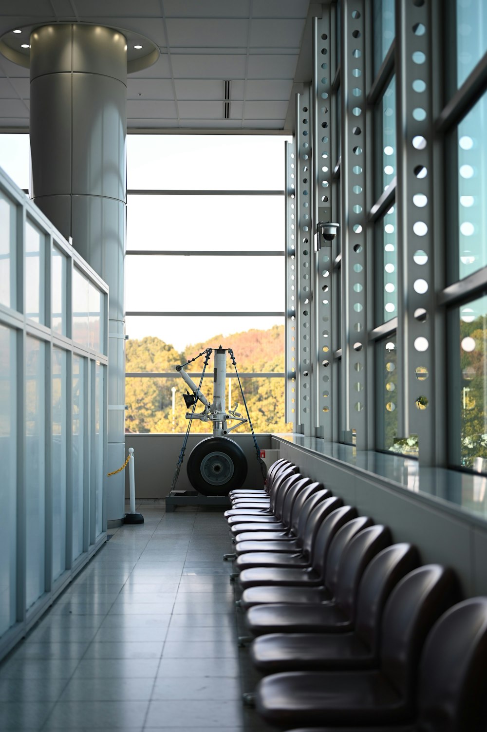 a long row of chairs sitting in front of a window