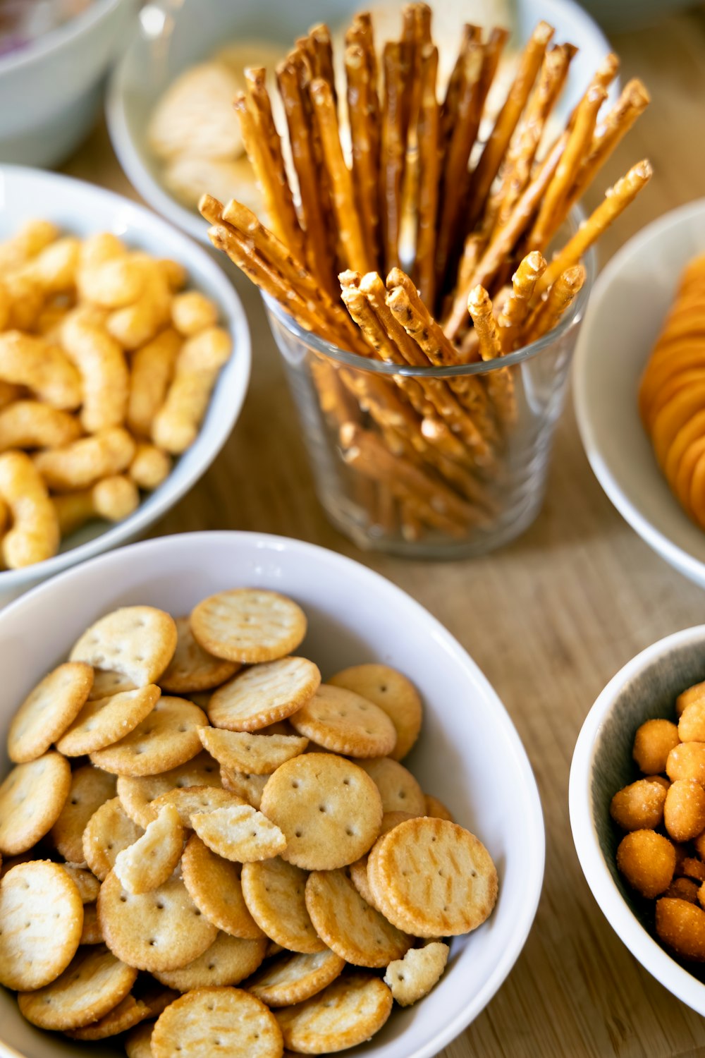 a wooden table topped with bowls of crackers