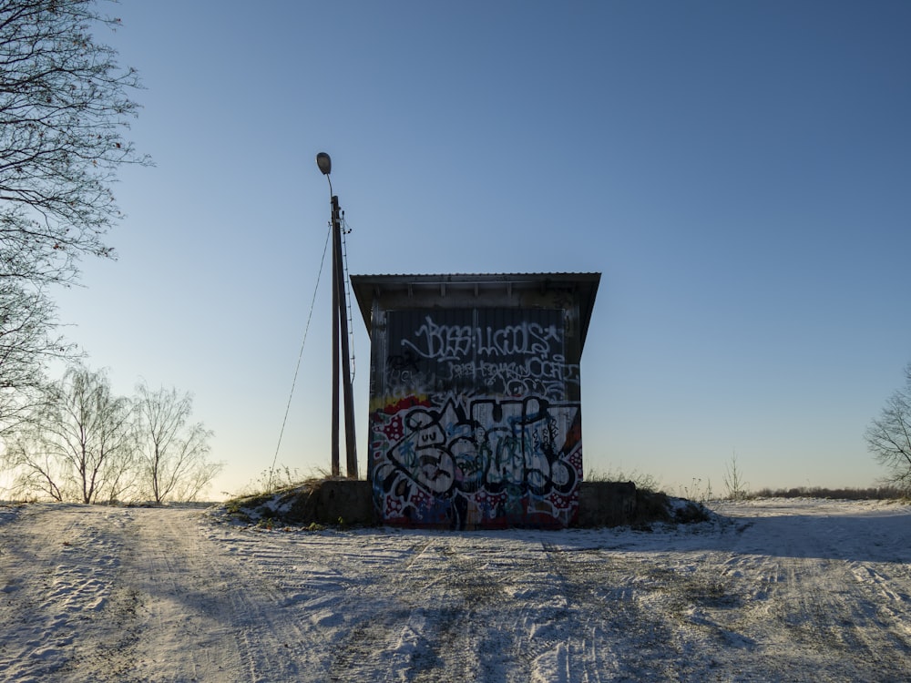 a train car covered in graffiti sitting on top of a snow covered field