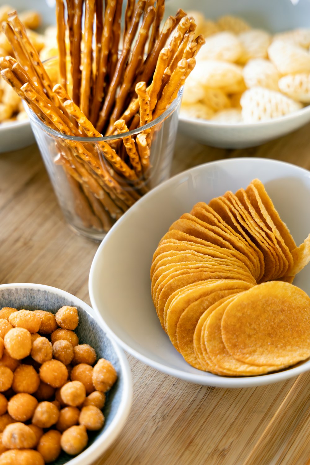 a wooden table topped with bowls of food