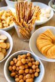 a wooden table topped with bowls of food