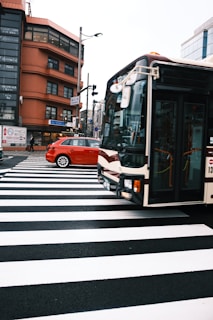A busy intersection where a stick2earn branded car catches the eye of pedestrians and commuters.