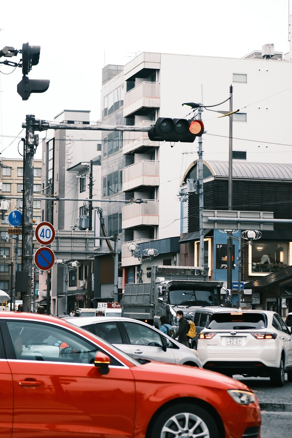 a red car is stopped at a traffic light