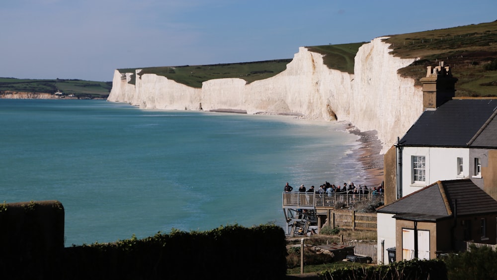 a group of people standing on the edge of a cliff