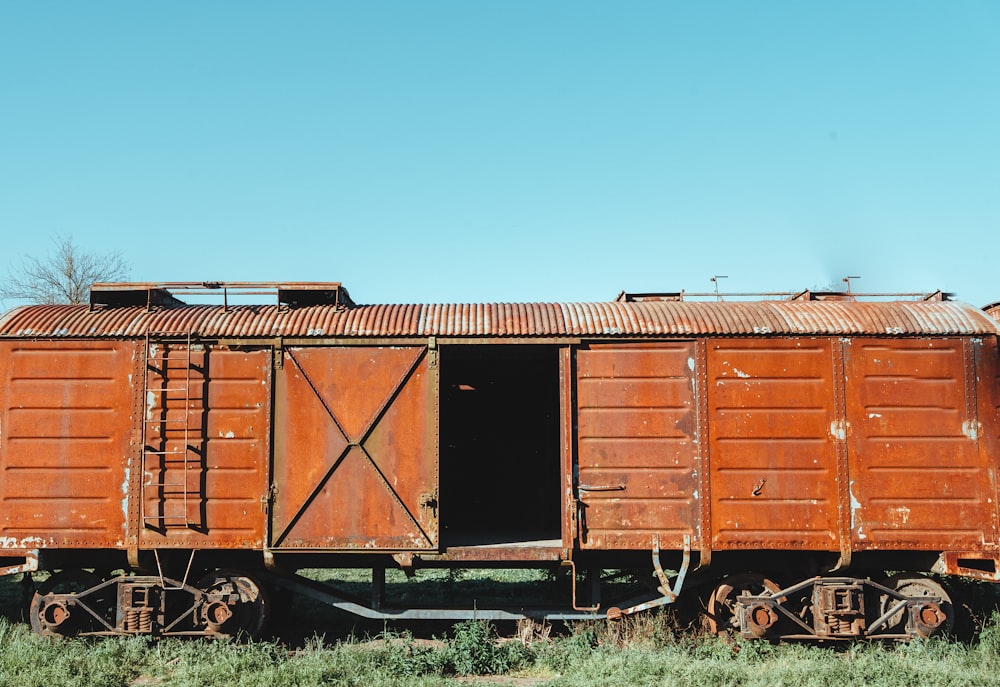 an old rusted train car sitting in a field