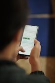 a person holding a cell phone in their hand