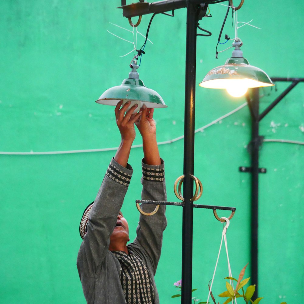um homem segurando uma luz acima de sua cabeça