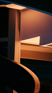 Close-up of an abstract 3D structure with sharp angles and deep shadows in dark mode.