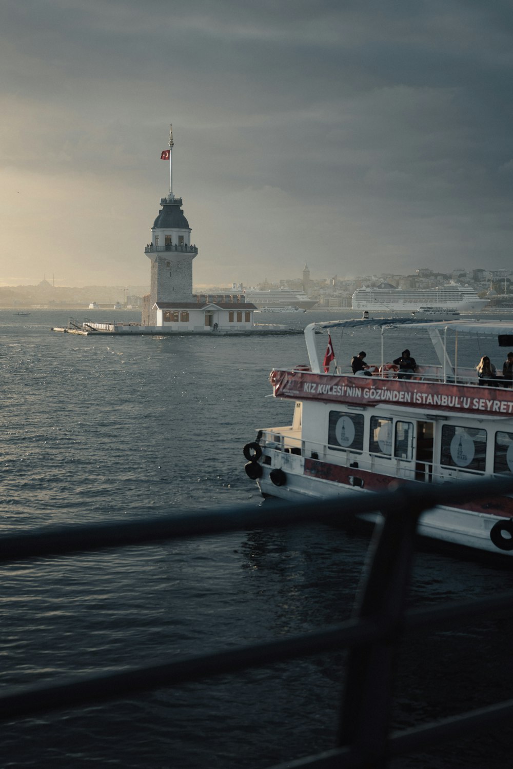 a boat is in the water near a lighthouse