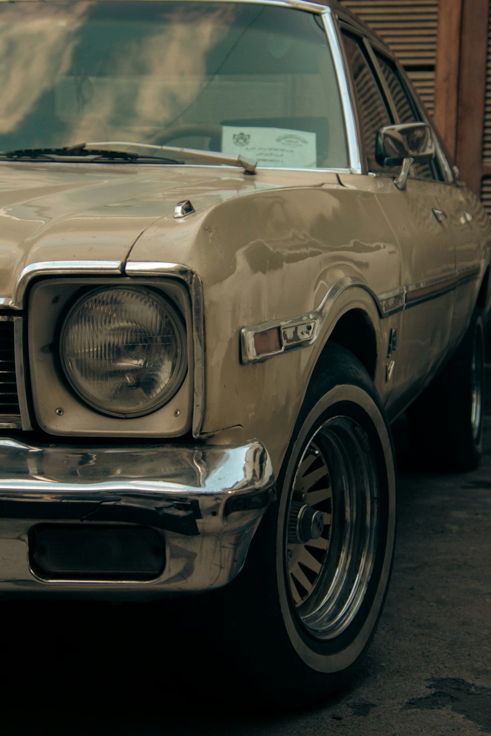 an old car parked in front of a building