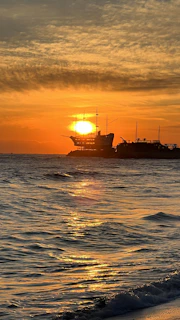 The Straw Hat crew sailing on the Thousand Sunny under a dramatic sunset sky.