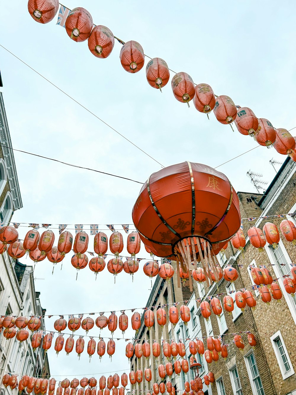 a bunch of red lanterns hanging from a line