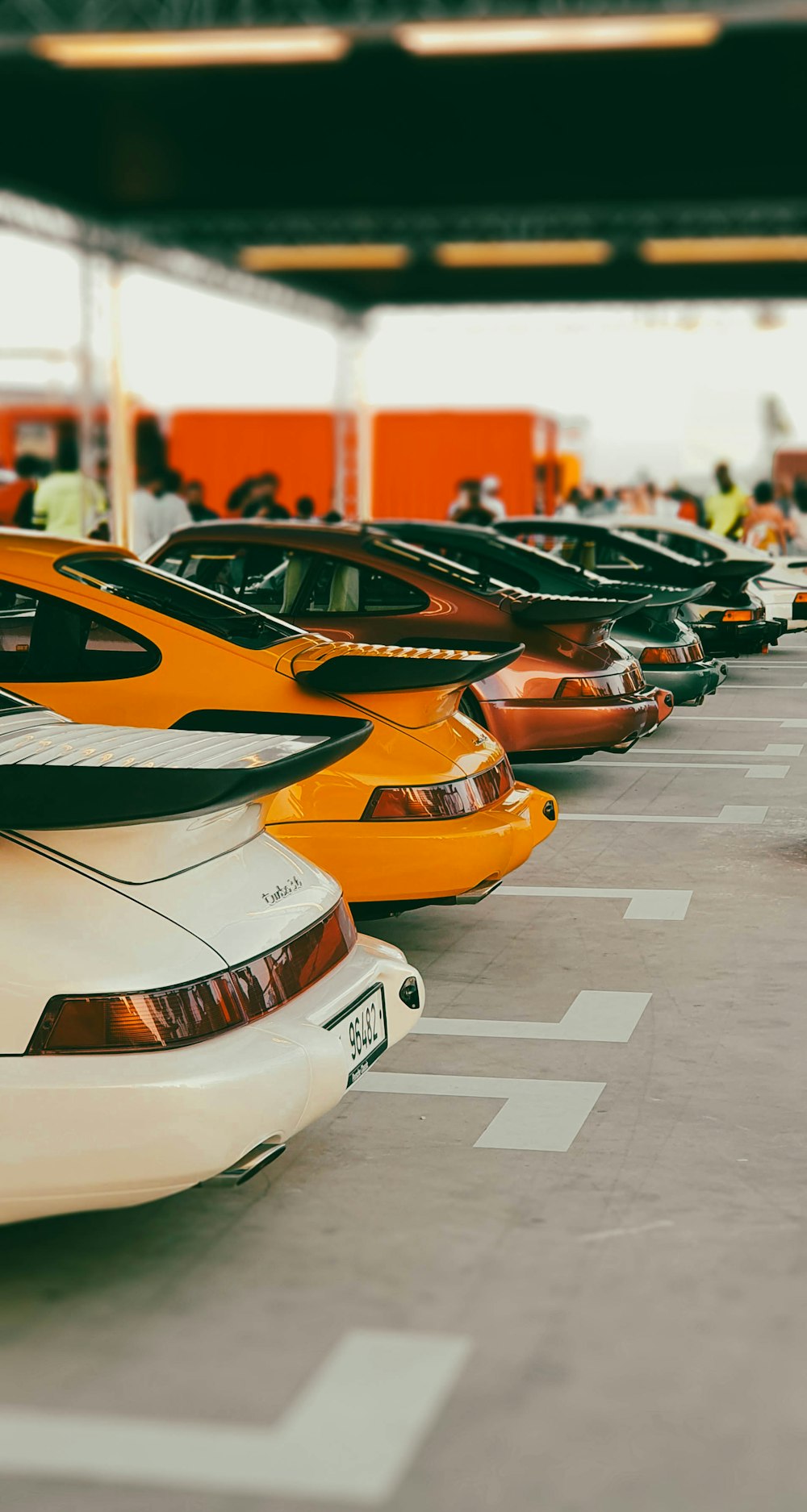 a row of parked cars sitting next to each other