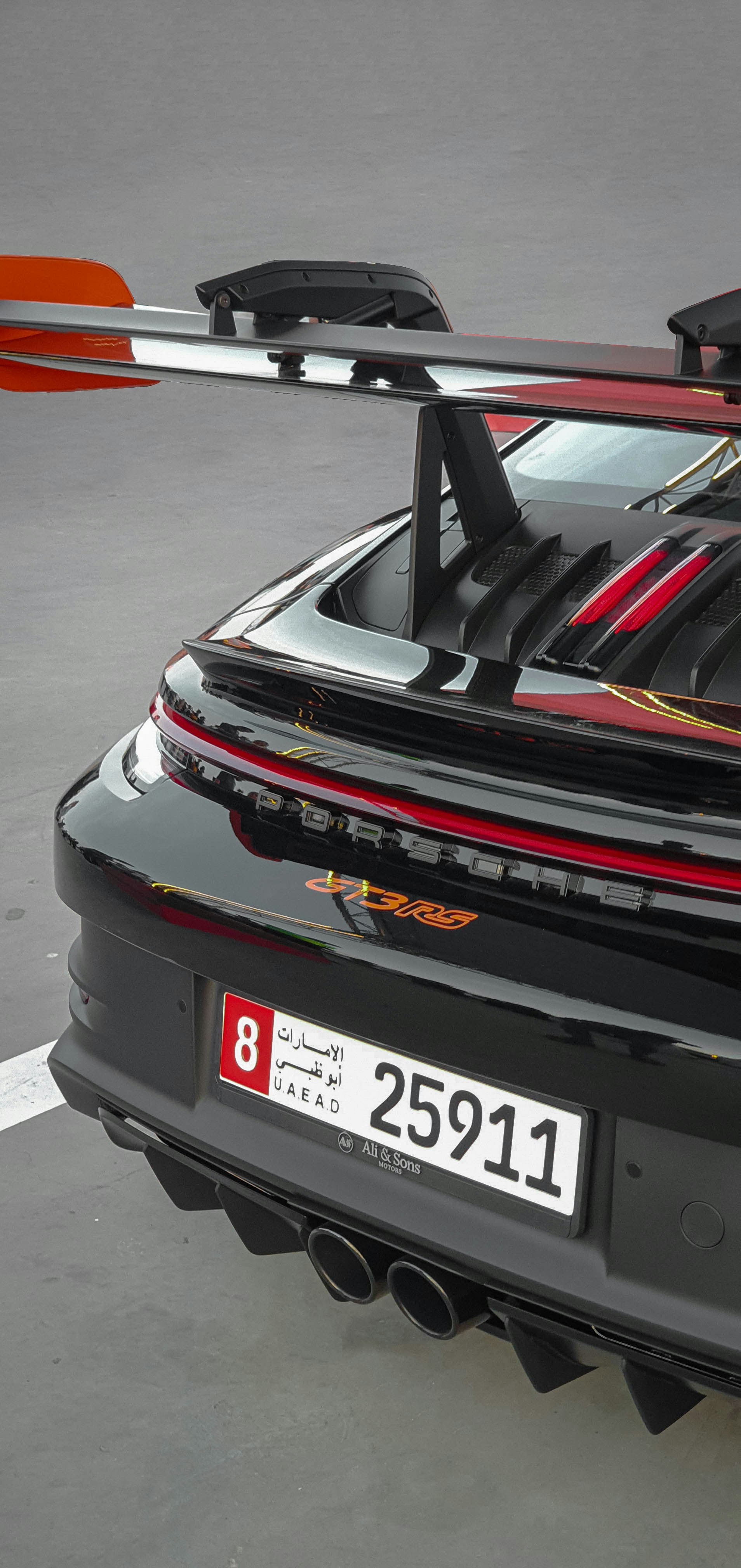 a black sports car parked in a parking lot