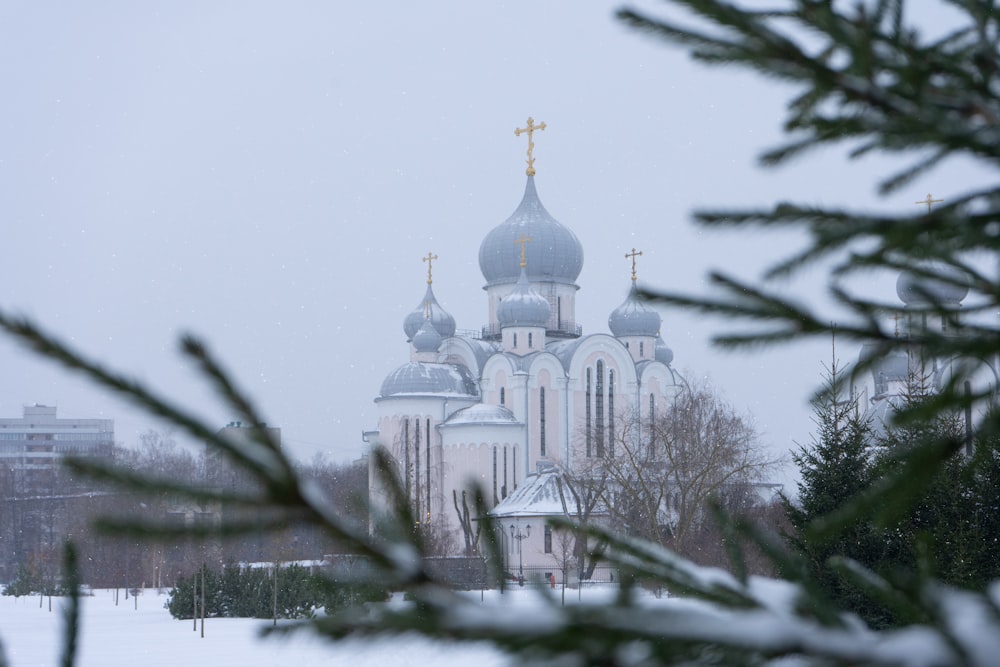 a church with a cross on top of it in the snow