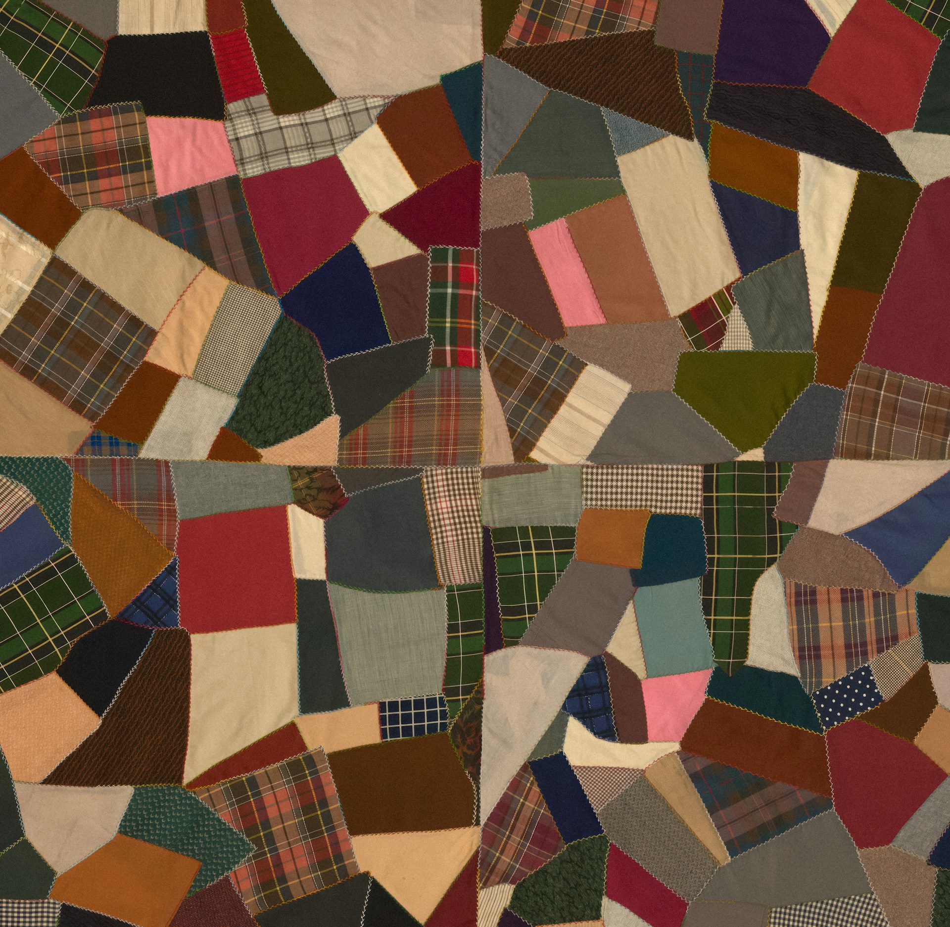 a patchwork quilt with many different colors and patterns