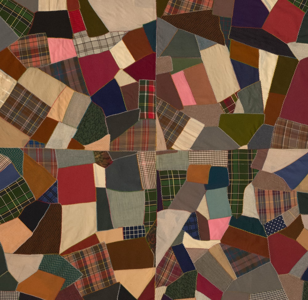 a patchwork quilt with many different colors and patterns