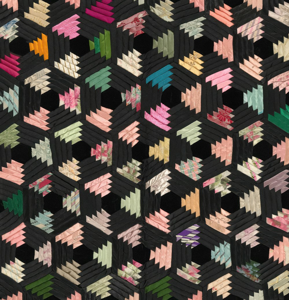 a close up of a quilt with many different colors