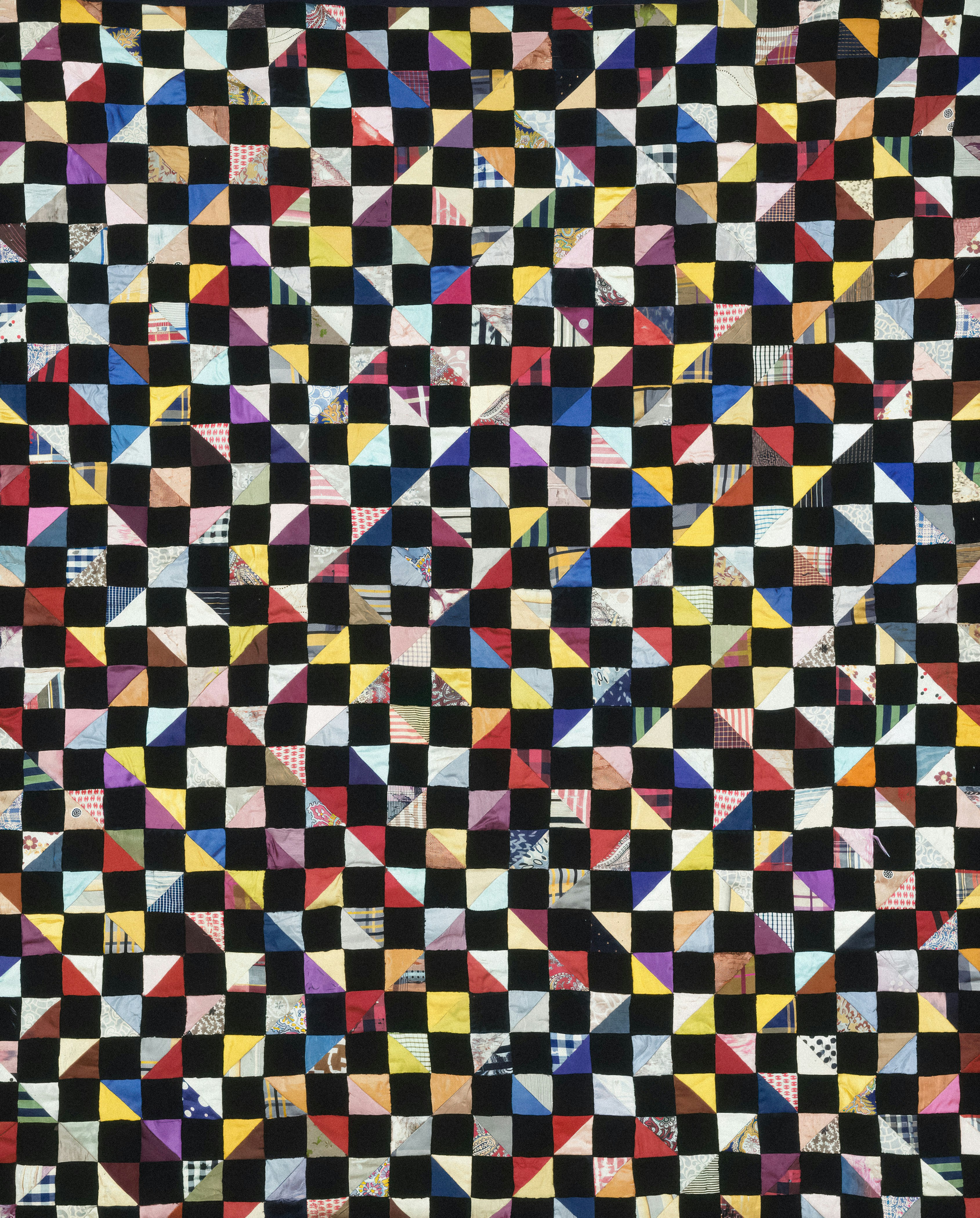 A black and white checkered quilt with different colors photo Free