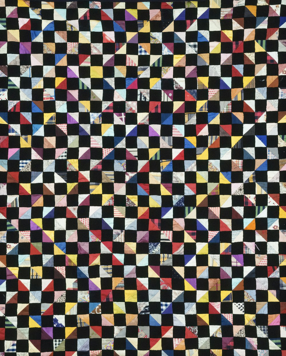 a black and white checkered quilt with different colors