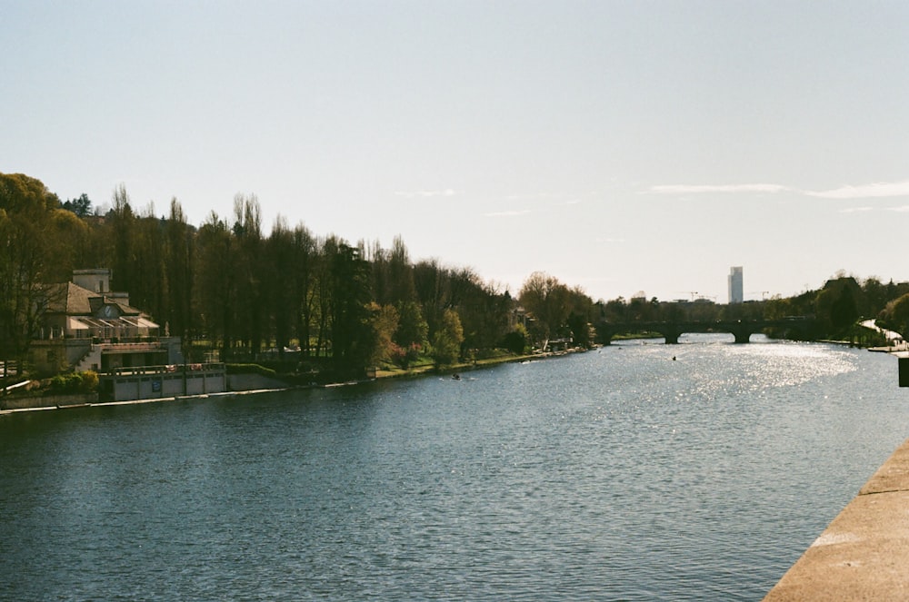 a body of water with a bridge in the background