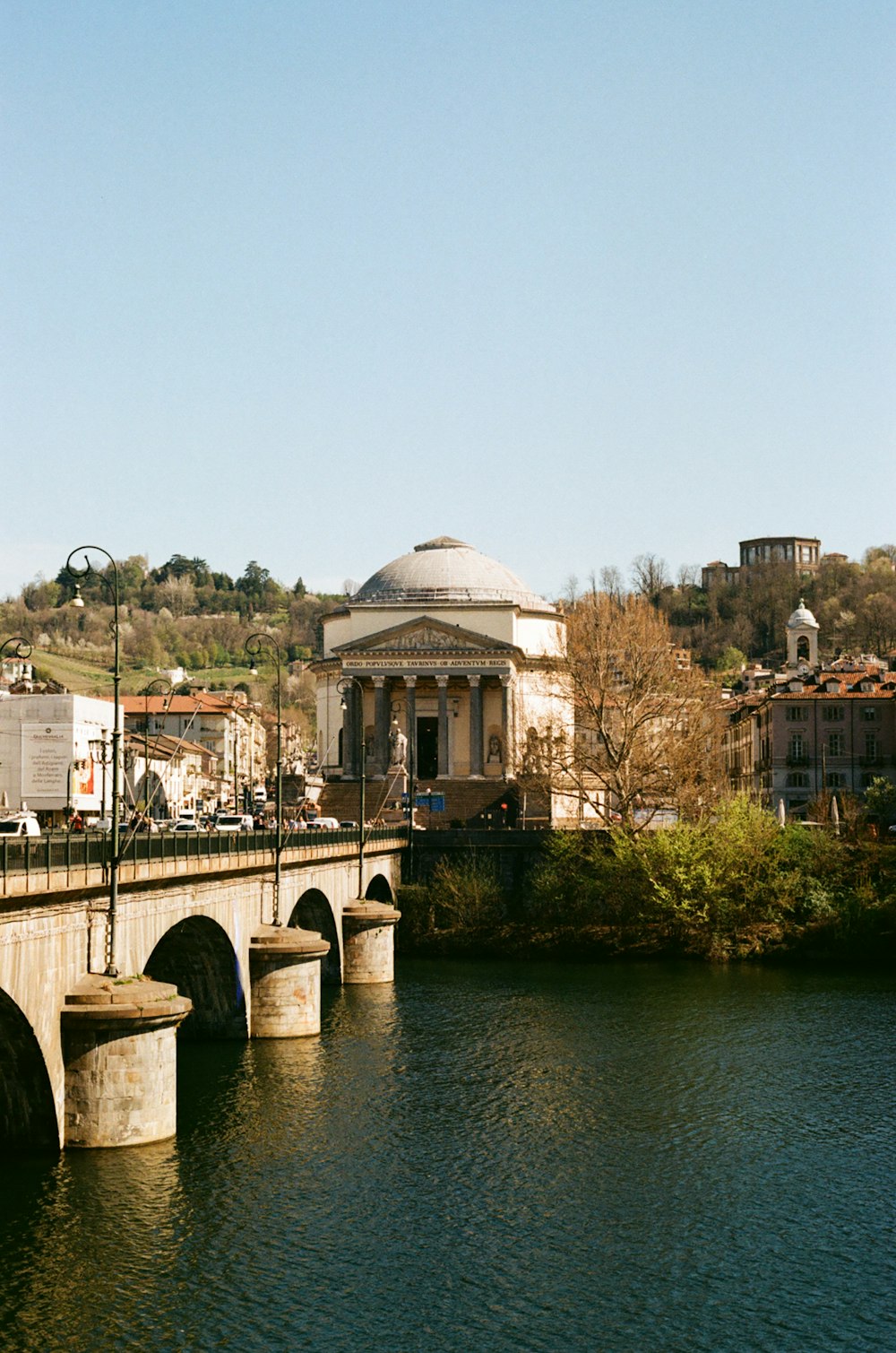 a bridge over a body of water with a building in the background