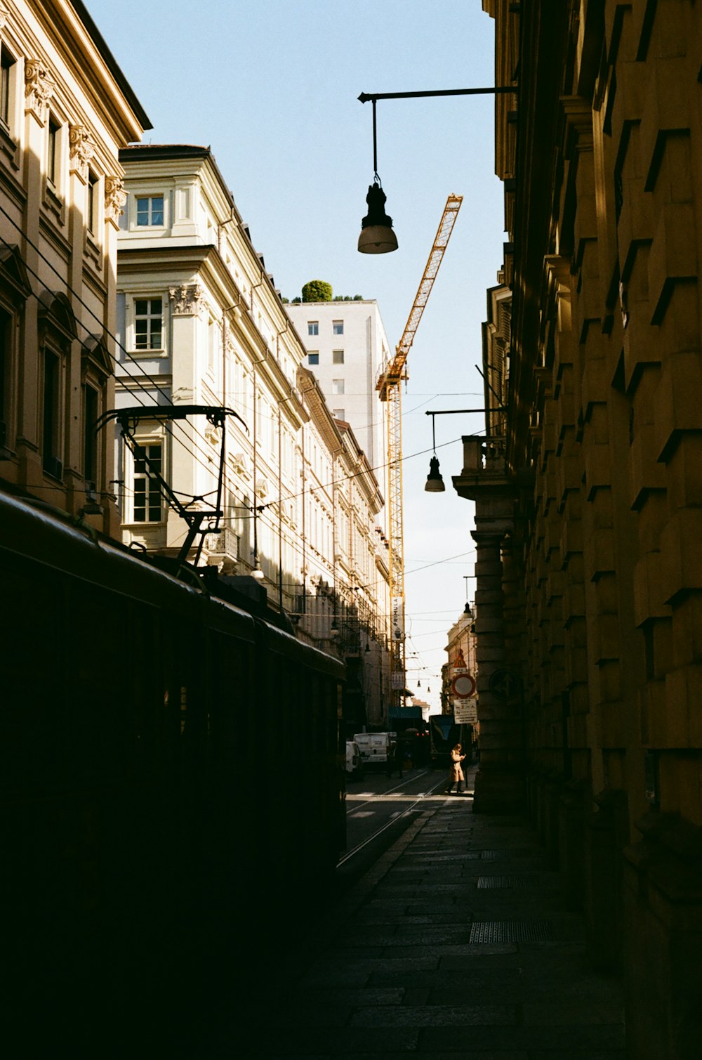 a view of a city street with a crane in the background