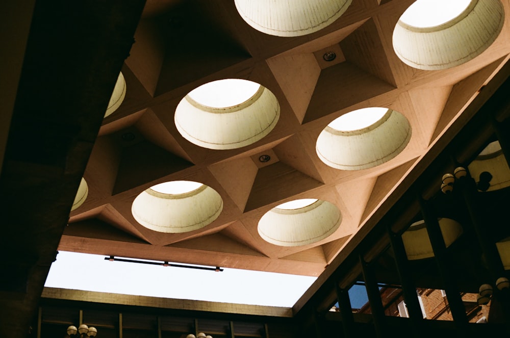 the ceiling of a building with round lights