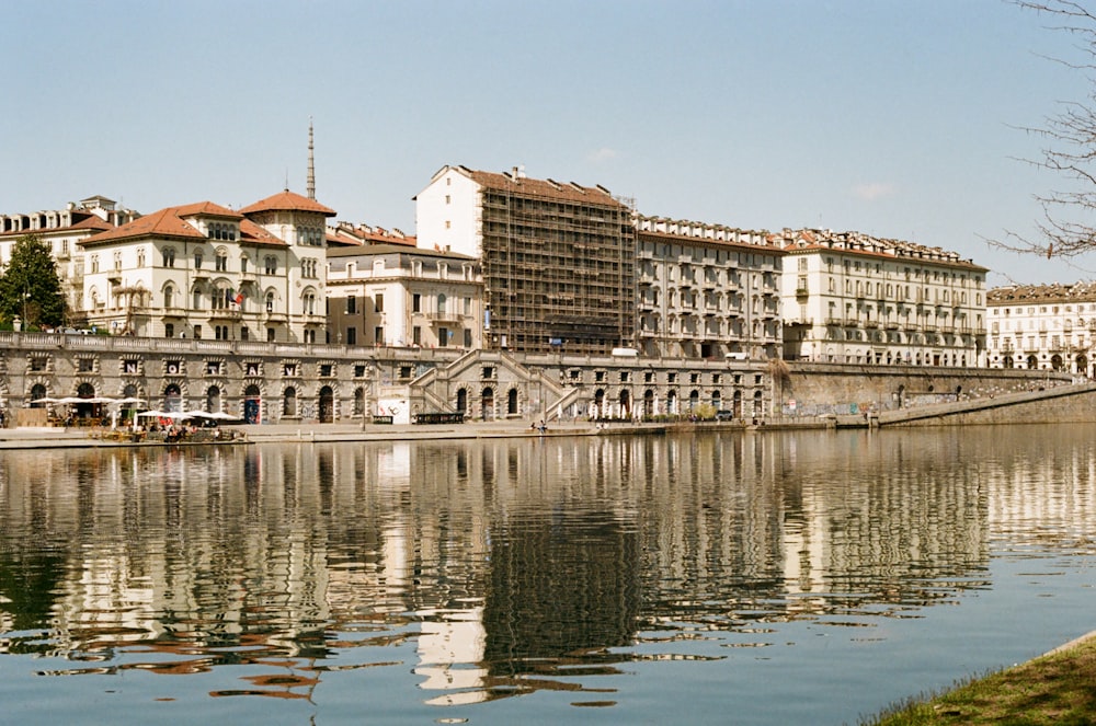 a body of water with buildings in the background