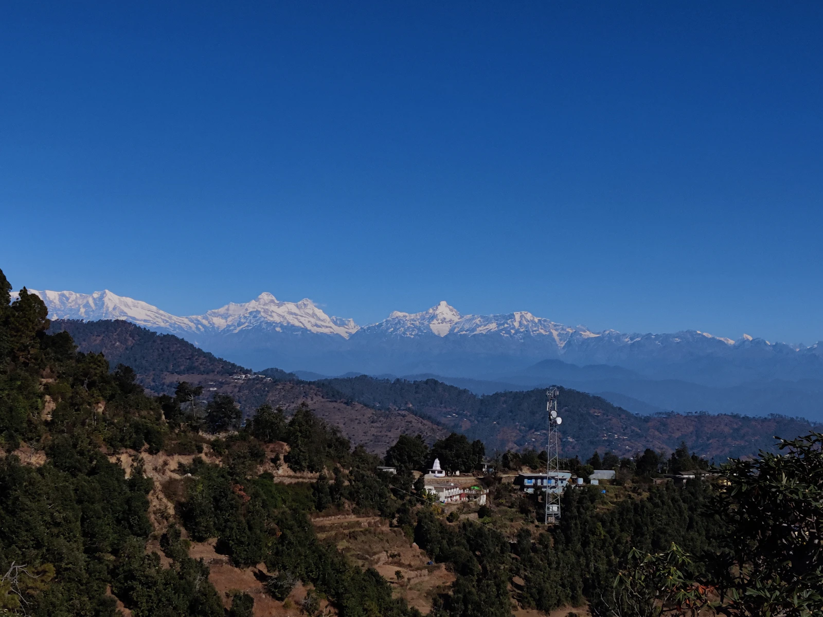 Snow-capped Himalayan peaks under a clear blue sky, viewed from Almora, Uttarakhand