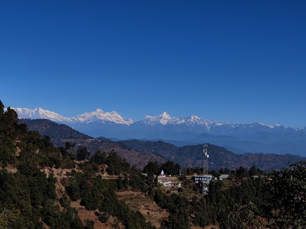 a view of a mountain range with snow capped mountains in the distance