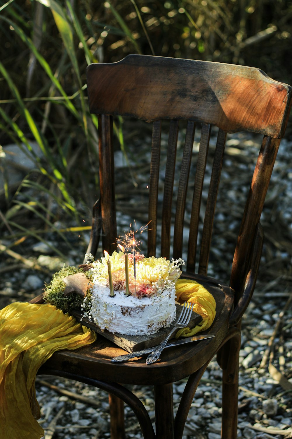 a birthday cake sitting on top of a wooden chair
