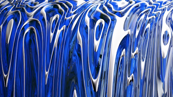 Abstract flowing patterns featuring glossy, elongated curves in blue and silver tones. The design creates a sense of fluid motion and depth, reminiscent of liquid metal.